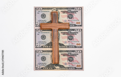 Banknotes with wooden cross photo