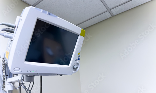 Hospital monitor displaying vital signs: heart rate, blood pressure, oxygen levels, crucial for patient health and medical assessment © Your Hand Please