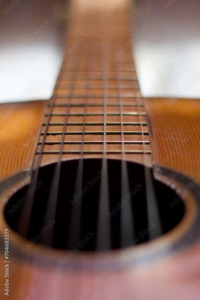 neck and headstock of an acoustic guitar on aged white wood, romantic, melancholic, solitary, thoughtful, reflective concept. neck and headstock of an acoustic guitar on aged white wood, romantic, melancholic, solitary, thoughtful, reflective concept.
