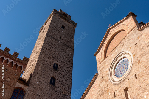 Main square Piazza del Duomo in San Gimignano with its famous palace towers, the big tower of Palazzo Comunale and the cathedral in the center photo