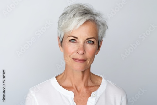 Closeup portrait of beautiful senior woman with grey hair looking at camera