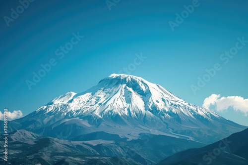 Pristine snow-capped mountain under a clear blue sky