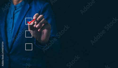 Checklist concept, business person checklist tick answer sign in checkbox, validation online questionnaire quality control document, man use pen to tick correct sign mark in checkbox form. photo