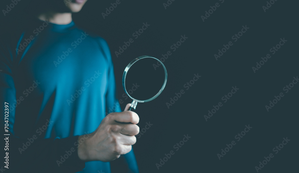 Man use hand lens glass magnifier search for best option on black background. Discover, find, inspector, team, Data Search, Search for information, Marketing, Human Resource Management HRM concept Man use hand lens glass magnifier search for best option on black background. Discover, find, inspector, team, Data Search, Search for information, Marketing, Human Resource Management HRM concept