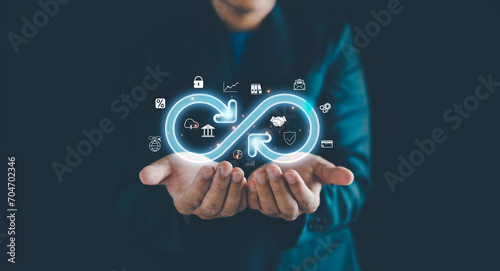 Businessman Hands holding virtual infinity with technology marketing online icon, a symbol of connection to community metaverse world network system and Technology data link concept.