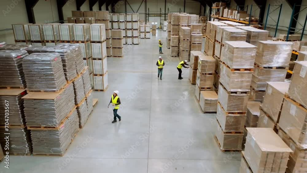 Top view of full team of warehouse employees walking in warehouse. Team of workers, managers, female director in modern industrial factory, heavy industry, manufactrury.