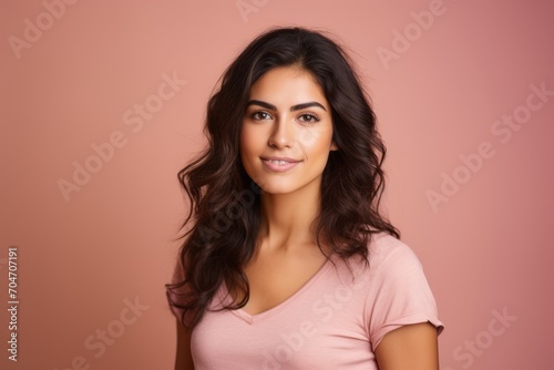 Portrait of beautiful young woman with long curly hair on pink background © Chacmool