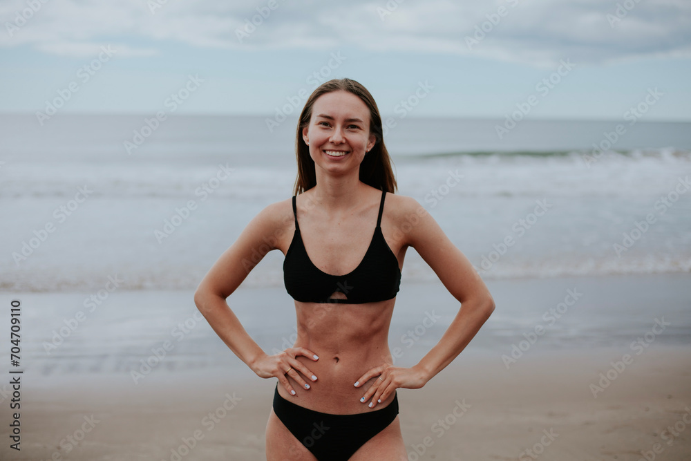 Beautiful ukrainian woman in black bikini on tropical beach. Portrait of happy young woman smiling at sea. Brunette tanned girl in swimwear enjoying and walking on beach. Beautiful ukrainian woman in black bikini on tropical beach. Portrait of happy young woman smiling at sea. Brunette tanned girl in swimwear enjoying and walking on beach.