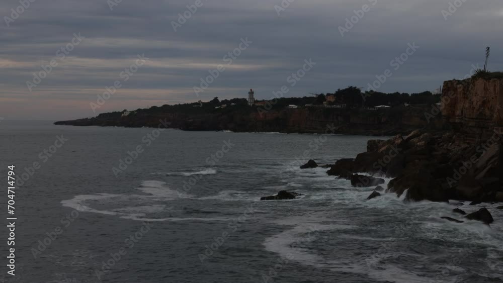 Time-lapse photography, cliff at the sea, Boca do Inferno with view to the lighthouse Faro da Guia, Cascais, Portugal, Europe Time-lapse photography, cliff at the sea, Boca do Inferno with view to the lighthouse Faro da Guia, Cascais, Portugal, Europe