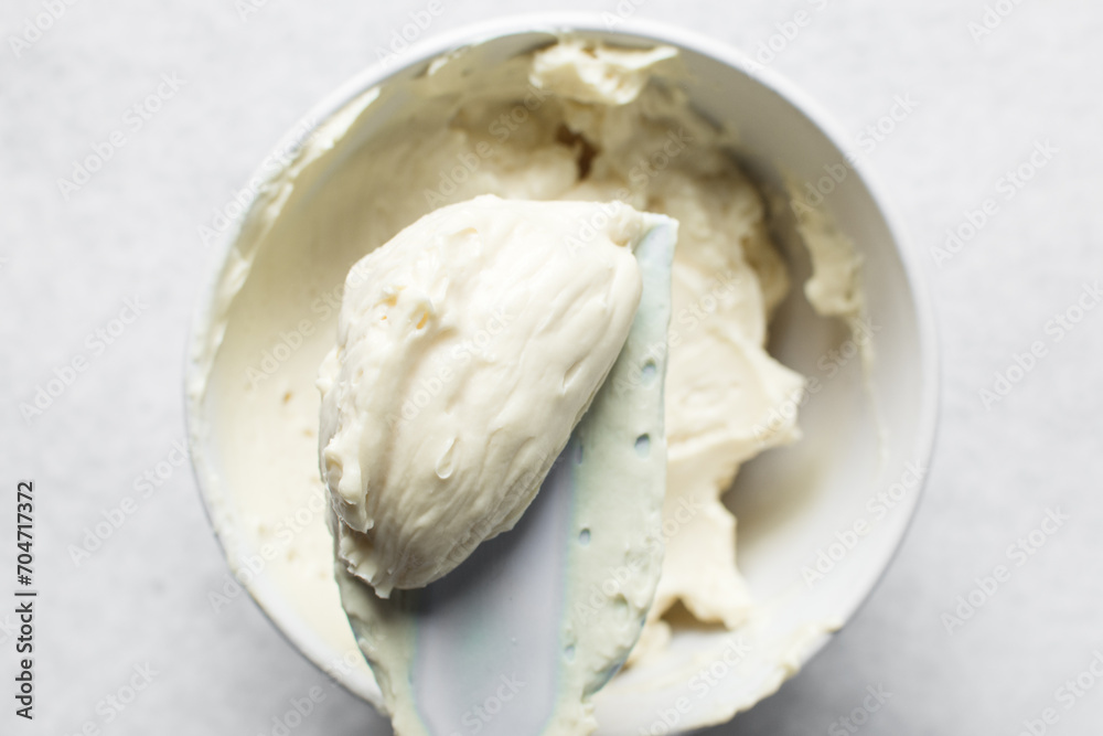 Top view of cream buttercream for decorating cake, silky smooth american buttercream on a spatula, overhead view of smooth buttercream