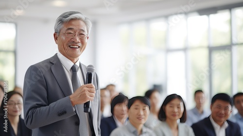 Asian senior business man in front of a group