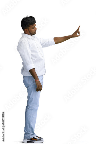 A man in a white shirt, on a white background, in full height, shows a victory sign, profile