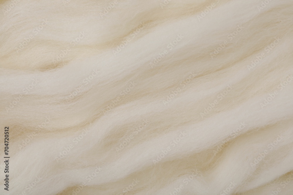 White felting wool as background, closeup view White felting wool as background, closeup view
