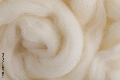 White felting wool as background, closeup view