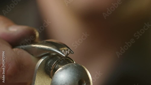 Wallpaper Mural Extreme close up - a jeweler fixes a precious stone in a gold ring Torontodigital.ca