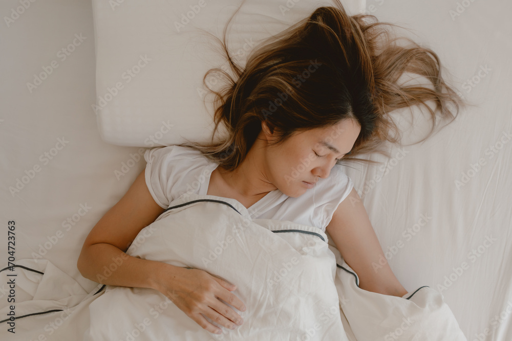 Asian woman sleeping on white bed, fully sleep and rest until morning time. Asian woman sleeping on white bed, fully sleep and rest until morning time.