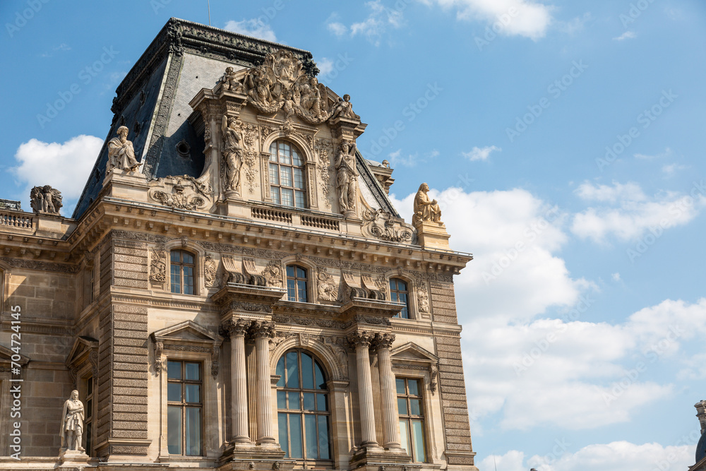 Paris, France - May 20, 2023: view on the Louvre palace and the Tuileries gardens with people