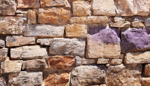 A purple and brown stone wall background.