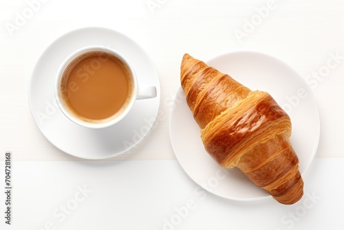 Creative layout of a croissant and coffee cup isolated on a white background for a healthy and sweet French breakfast concept Flat lay and top view design elem