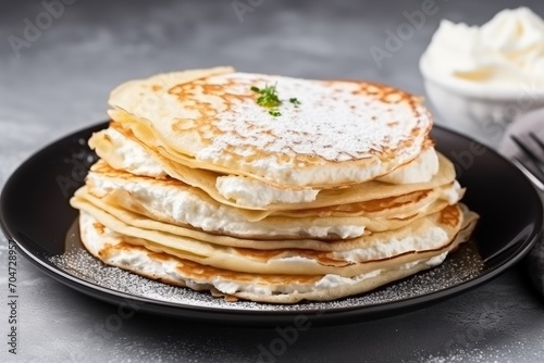 Cottage cheese-filled crepes on a grey surface.