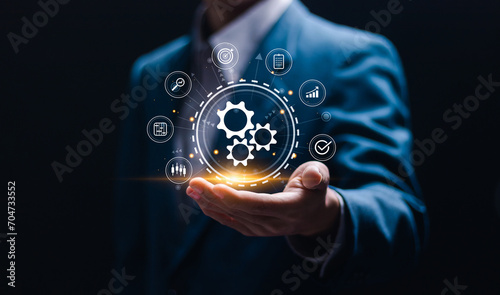 Automation concept. Businessman holding with virtual operations management technology related to business processes and workflows, high performance, monitoring and evaluation.