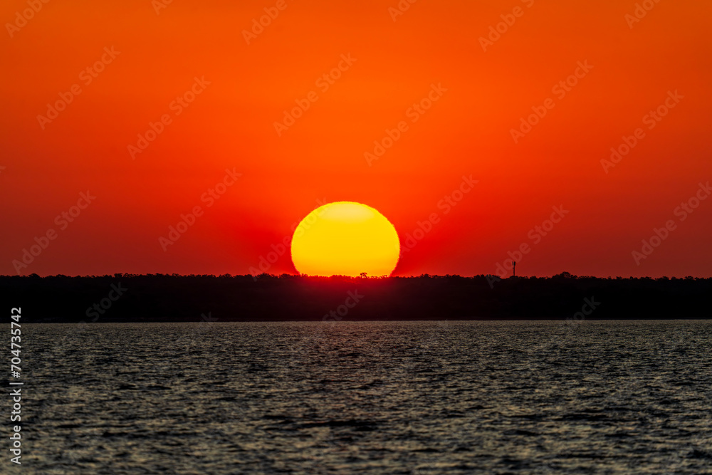 Dramatic sunset on the horizon at Cullen Bay, Darwin.