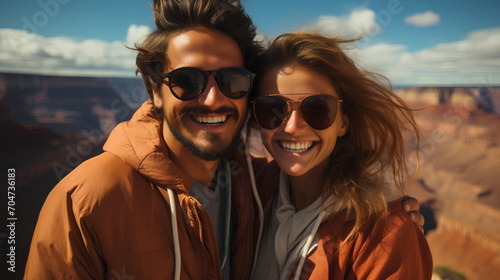 Attractive couple at a large canyon - low angle close-up shot - vacation - getaway - mountains - skiing - holiday - escape - honeymoon - Alaska 