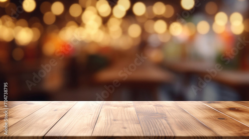 An empty wooden table surface with a warm, bokeh light background, suitable for product display or montage.