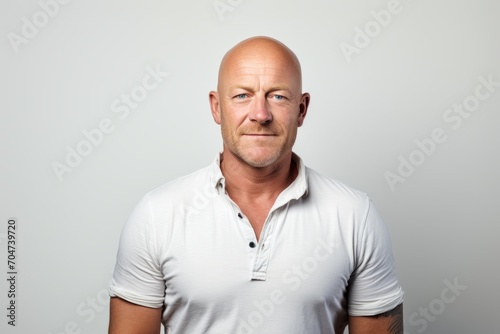 Portrait of a bald man in a white t-shirt. © Inigo