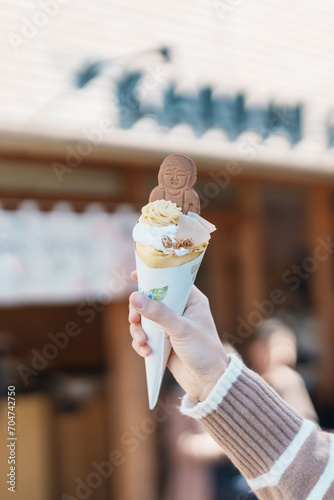 Woman showing Daibutsu or Buddha yogurt crepe, popular dessert in Kamakura, Kanakawa, Japan photo