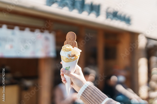 Woman showing Daibutsu or Buddha yogurt crepe, popular dessert in Kamakura, Kanakawa, Japan photo