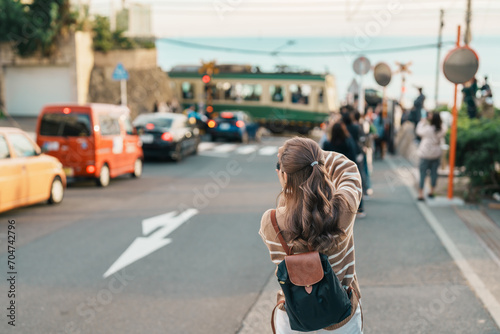 Woman tourist Visiting in Kamakura, Kanagawa, Japan. happy Traveler sightseeing Kamakurakokomae train station. Landmark and popular for tourists attraction near Tokyo. Travel and Vacation concept photo