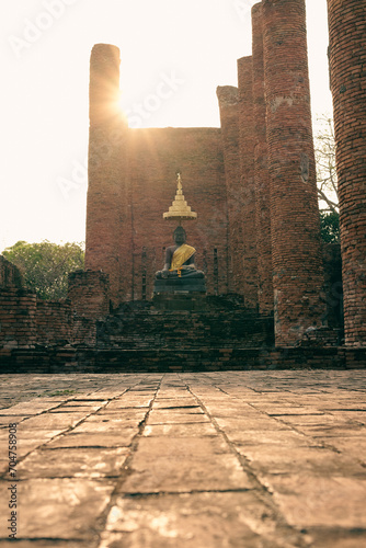 Black buddha statue sit at ancient temple ruins which archaeological place and landmark at Ayuttaya province in Thailand. photo