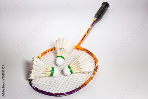 three shuttlecocks Placed on a badminton racket © Thana