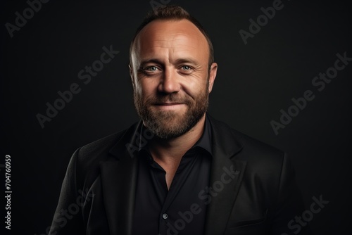 Portrait of a handsome middle-aged man on a dark background.