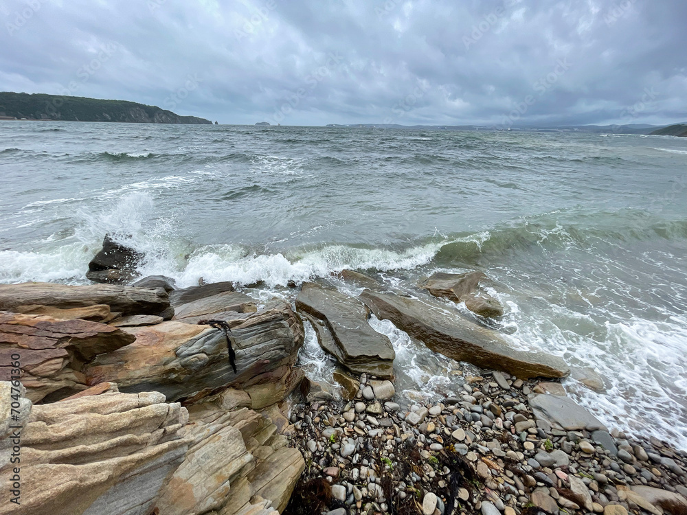 Vladivostok, waves in the Ussuri Bay near Patroclus Bay in cloudy summer weather