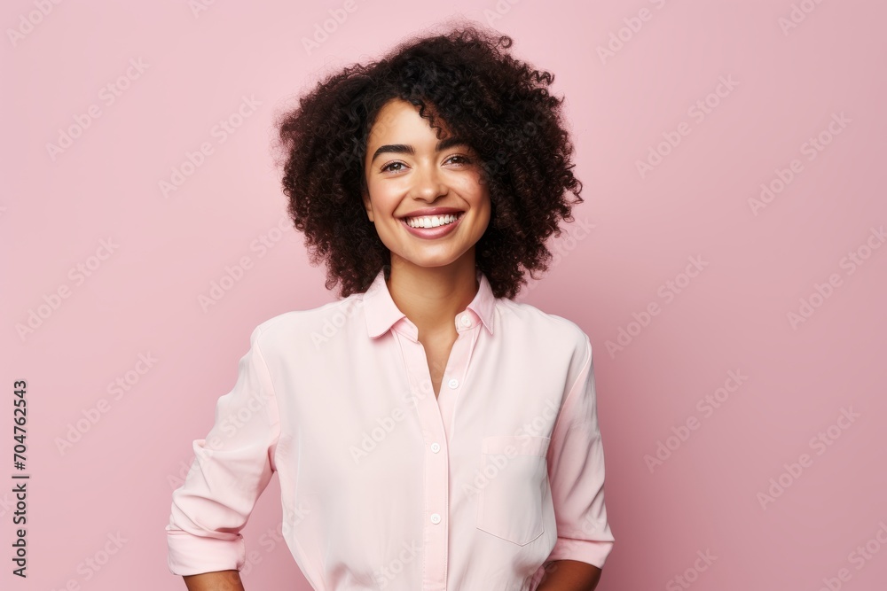 Happy african american woman looking at camera and smiling over pink background Happy african american woman looking at camera and smiling over pink background