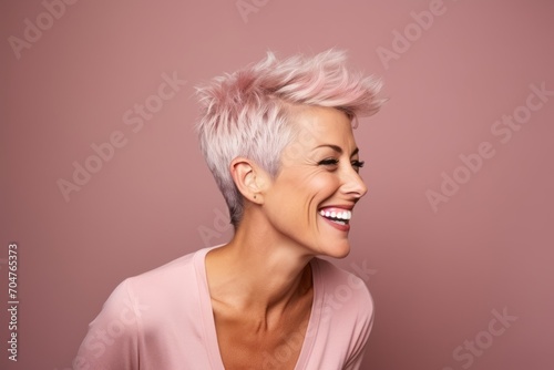 Portrait of a happy woman with pink hair on a pink background