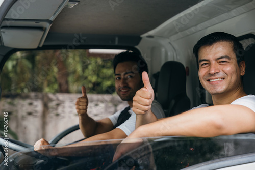 Bilde på lerret Truck driver and mover workers in uniform providing relocation service