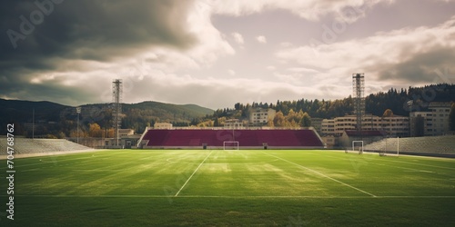 Empty soccer stadium with green field and red seats under cloudy sky