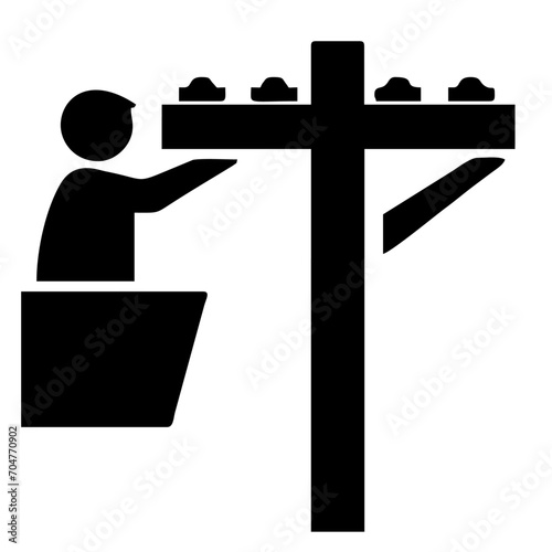 silhouette of person working on light poles
