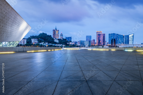 Empty square floors and modern city buildings at night in Macau