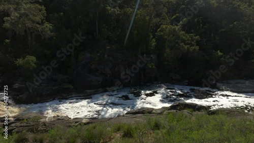 Flying out over the Frankland river from the viewing platform, with rapids visible in lower left corner. photo