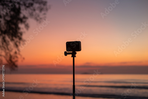 Tourists set up cameras to take pictures of the sea at sunset and twilight.