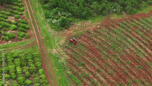 Drone aerial pan of tractor equipment machinery farming cultivation crops plantation agriculture industry on farm Santa María Misiones Argentina South America 4K photo