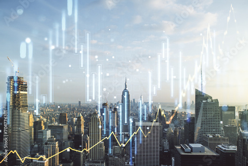 Double exposure of abstract creative financial chart hologram on New York skyscrapers background  research and strategy concept