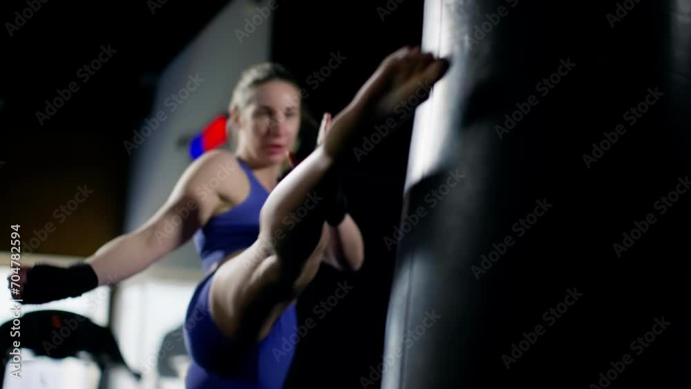 The girl does kicks. Slow motion. Workout in the gym. Low-key shooting. Taking care of yourself, playing sports. The girl does kicks. Slow motion. Workout in the gym. Low-key shooting. Taking care of yourself, playing sports.