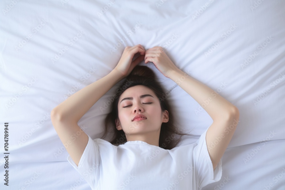 Young Asian woman sleeping on a bed