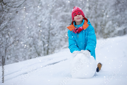 Happy little boy with a big snow globe. Happy winter holidays concept.