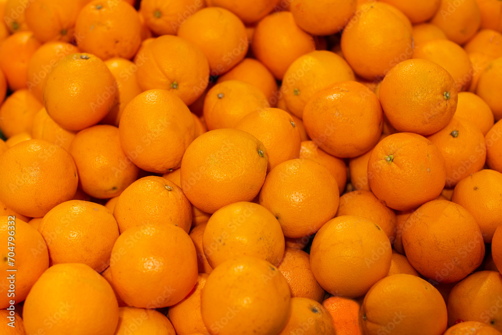 Background from yellow oranges. Tropical fruits.